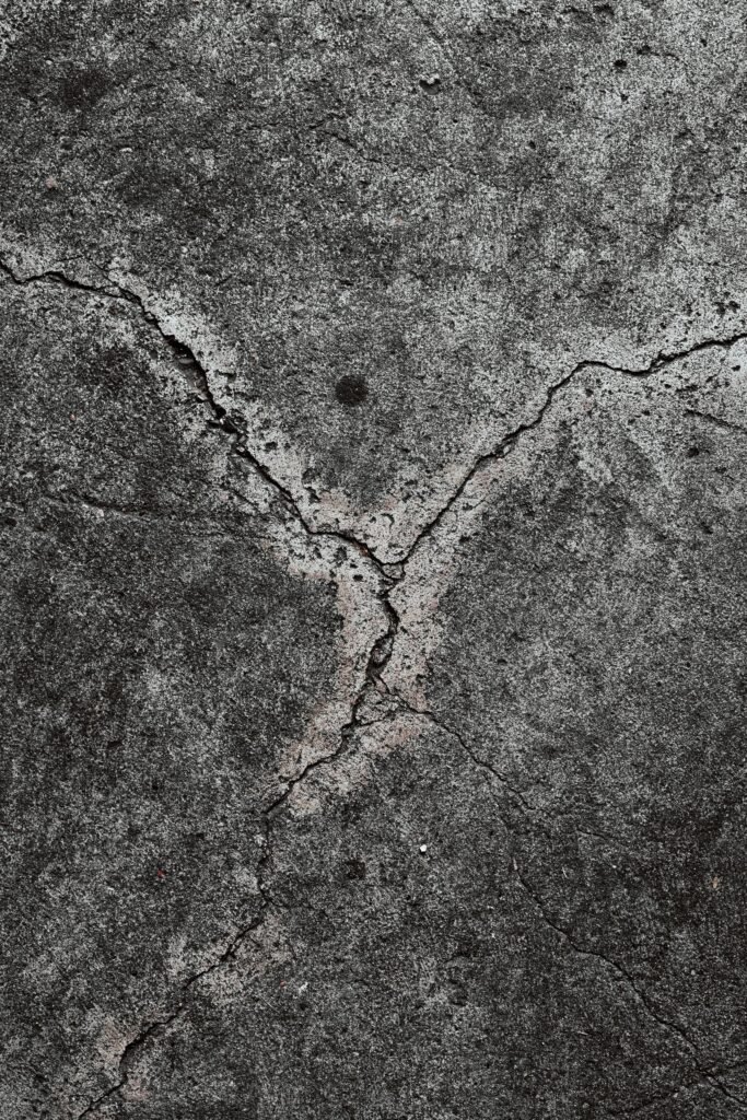 Close-up of cracked concrete surface before epoxy crack repair in Charleston