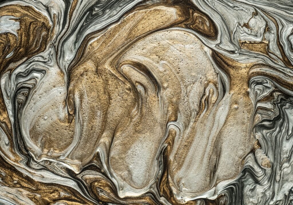 Elegant marbled art pattern with swirling golden and silver hues. Perfect for abstract art lovers.