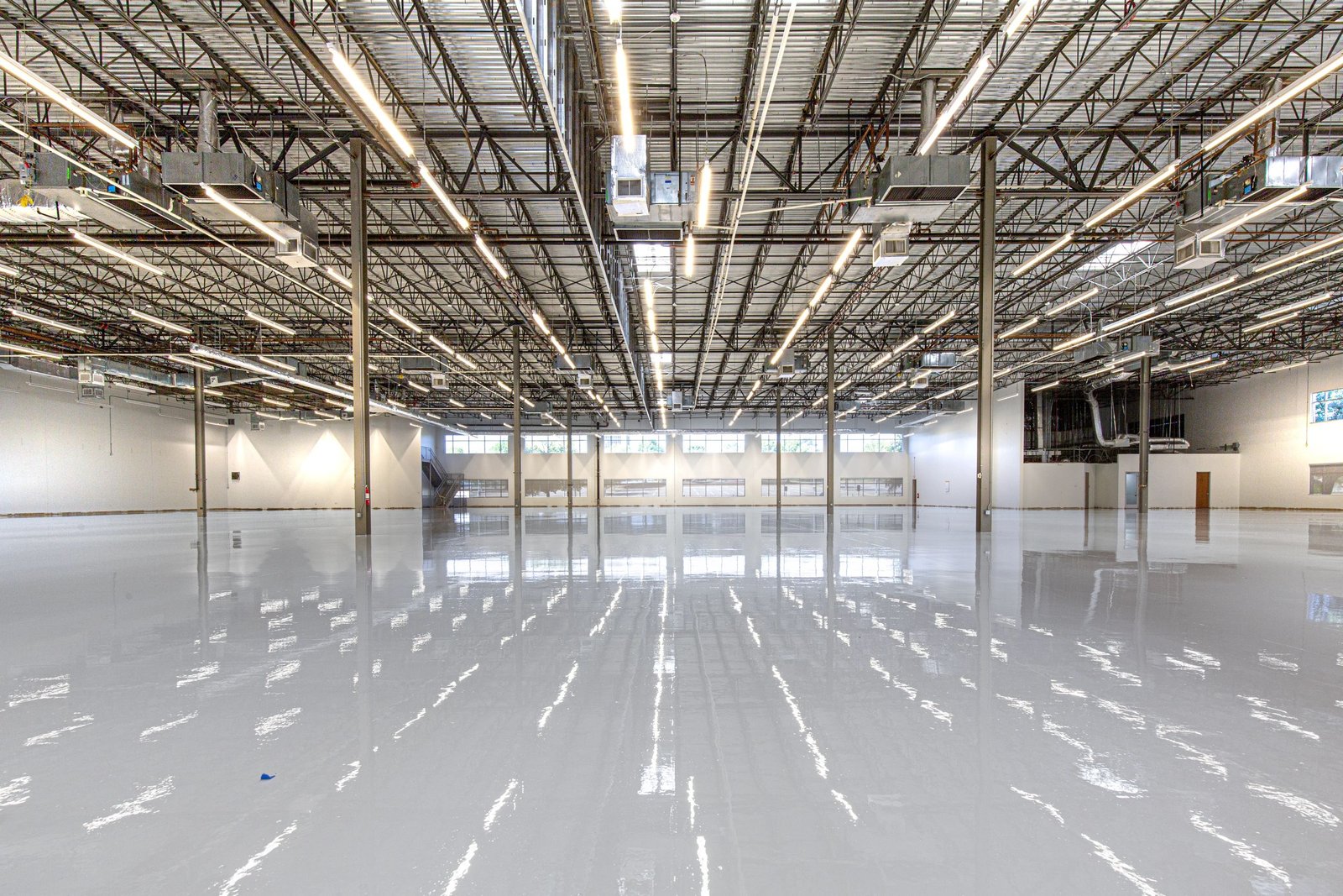 Spacious polished industrial facility with glossy epoxy flooring